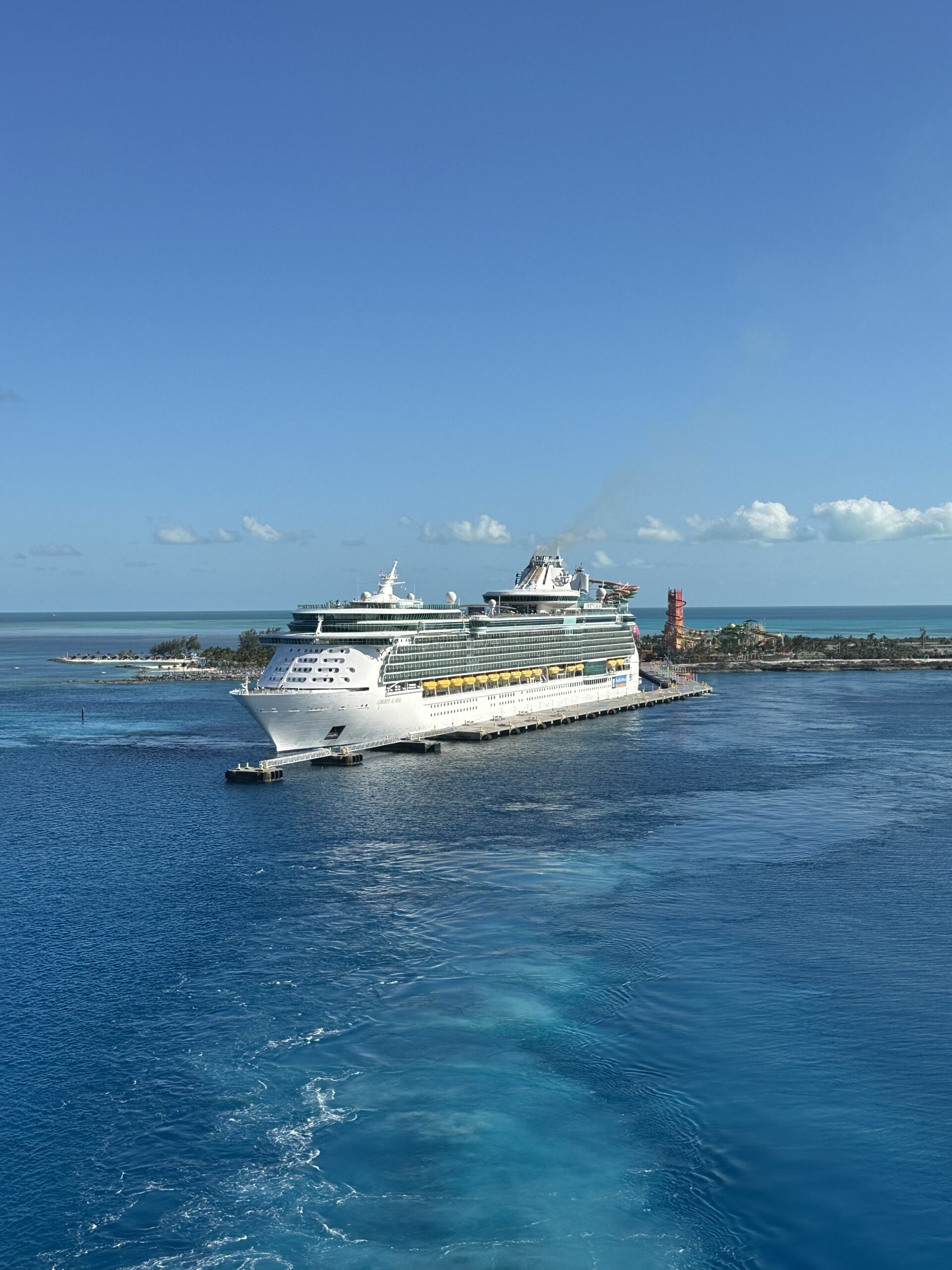 Cruise ship sailing across calm blue water